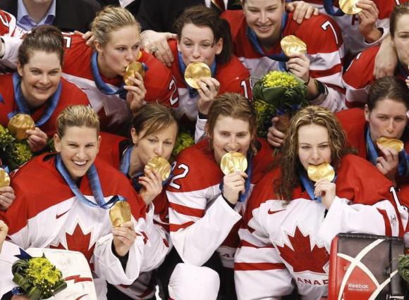 Team Canada pose after defeating the U.S. in the women's hockey gold medal game at the Vancouver 2010 Winter Olympics